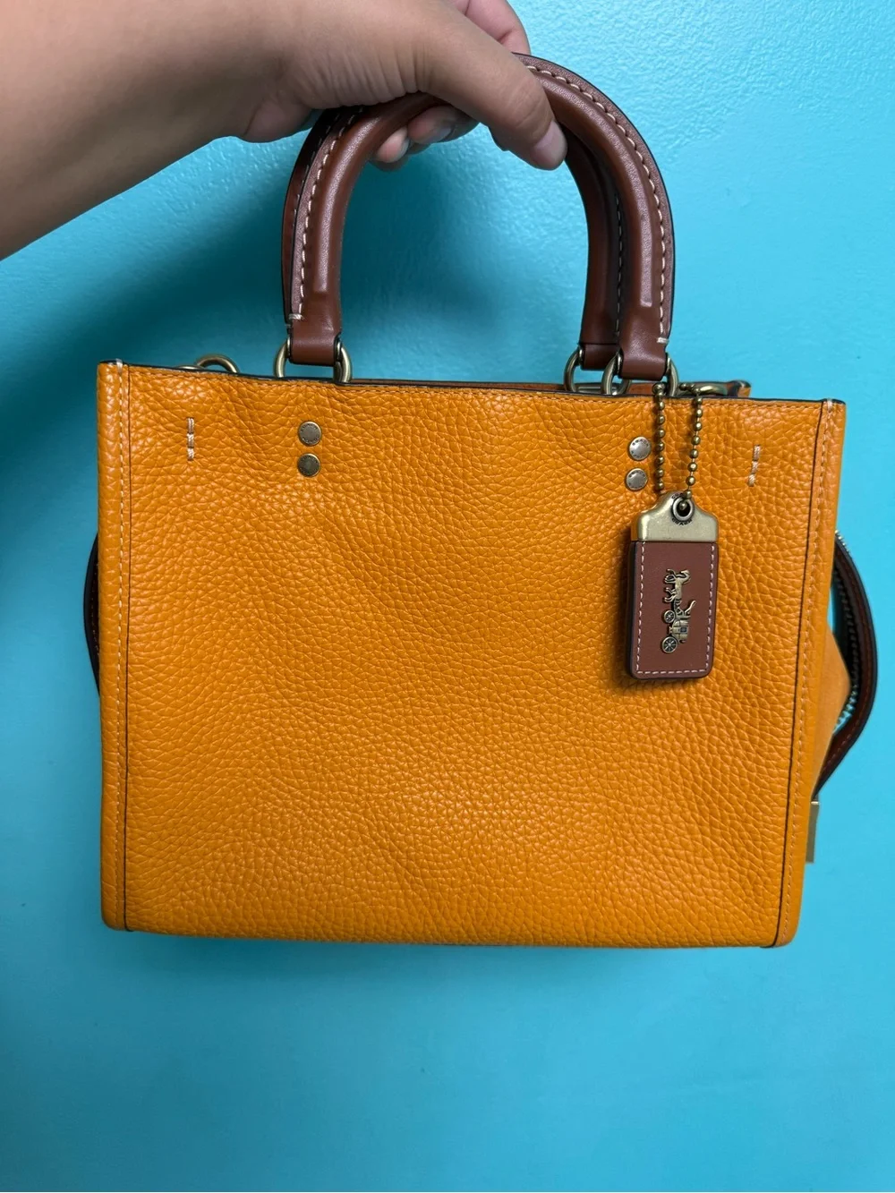Coach Pebbled rouge 25 in papaya orange